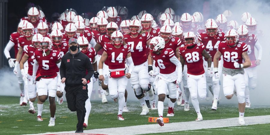 Scott Frost and the Huskers run onto the field before a Dec. 12 game against Minnesota at Memorial Stadium.