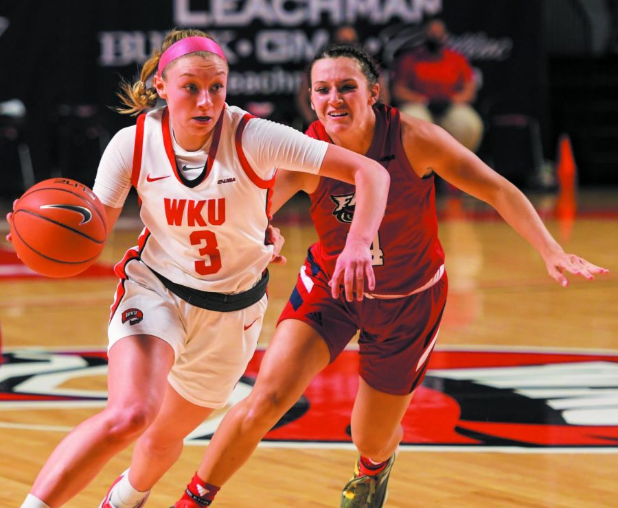 WKU guard Ally Collett (3) dribbles the ball across the court while FAU guard Are Beck (4) follows closely behind at the game at Diddle Arena on Feb. 5, 2021. WKU won 71-64.