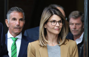 BOSTON, MA - APRIL 3: Actress Lori Loughlin and her husband Mossimo Giannulli, wearing green tie at left, leave the John Joseph Moakley United States Courthouse in Boston on April 3, 2019. Hollywood stars Felicity Huffman and Lori Loughlin were among 13 parents scheduled to appear in federal court in Boston Wednesday for the first time since they were charged last month in a massive college admissions cheating scandal. They were among 50 people - including coaches, powerful financiers, and entrepreneurs - charged in a brazen plot in which wealthy parents allegedly schemed to bribe sports coaches at top colleges to admit their children. Many of the parents allegedly paid to have someone else take the SAT or ACT exams for their children or correct their answers, guaranteeing them high scores. (Photo by Pat Greenhouse/The Boston Globe via Getty Images)