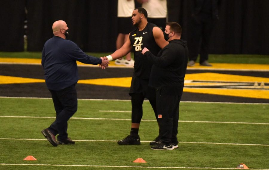 MU offensive lineman Larry Borom shakes the hand of Patriots offensive line scout