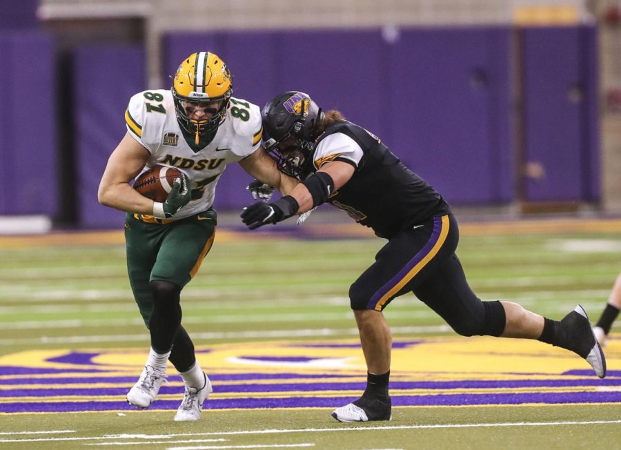 Northern Iowas Spencer Cuvelier reaches to make a tackle against North Dakota State Universitys Josh Babicz on Saturday in the Panthers season finale.