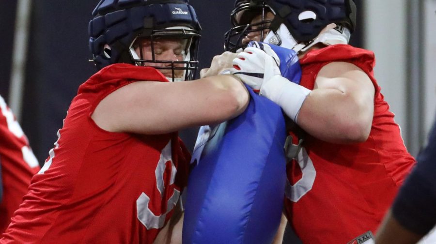 Center Josh McCauley locks horns with another lineman during drills at Arizona Wildcats second day of spring practice at Lowell-Stevens, March 3, 2020, Tucson, Ariz.
