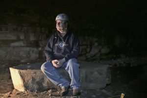 WKU Geology and Geography Professor Dr. Chris Groves sits in Crumps Cave, where he and other colleagues researched hydrology, ecology, archeology, geology and biology in 2015. The biological focus of their research was white nose syndrome – a disease threatening the lives of the federally endangered gray bats – which was discovered in Crumps Cave.