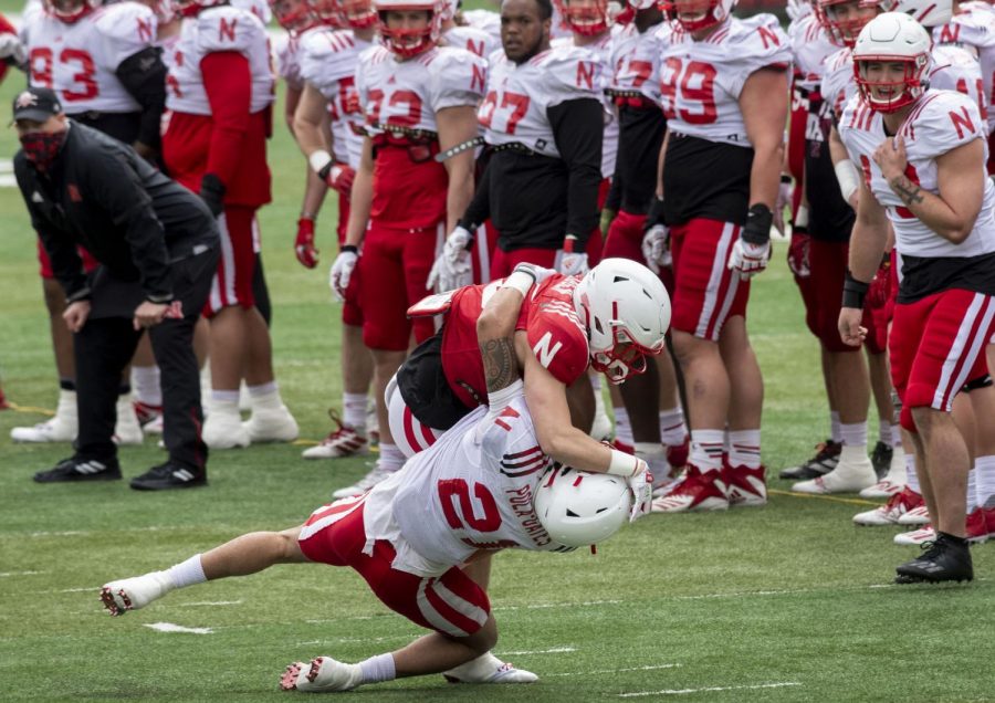 Nebraska running back Trevin Luben (35) runs with the ball against safety Noa Pola-Gates (21) on Saturday during a football practice at Memorial Stadium.