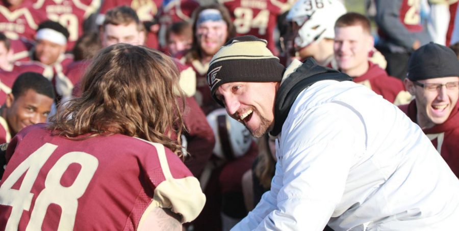 Eureka College football coach Kurt Barth, who is in his 12th season at his alma mater, talks to one of his players following a game.