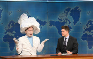 SATURDAY NIGHT LIVE -- Carey Mulligan Episode 1802 -- Pictured: (l-r) Bowen Yang as The Iceberg That Sank The Titanic and anchor Colin Jost during Weekend Update on Saturday, April 10, 2021 -- (Photo by: Will Heath/NBC)