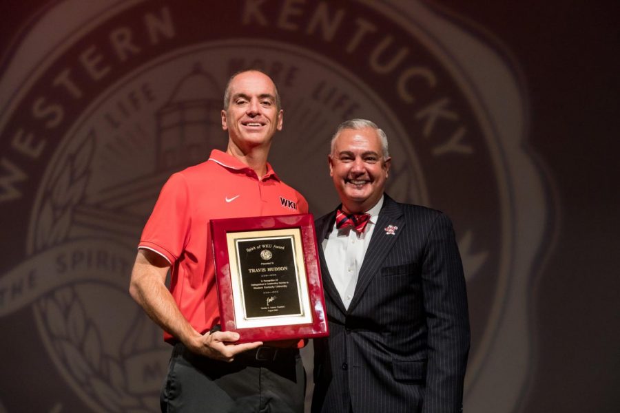WKU Volleyball head coach Travis Hudson accepts the 2021 Spirit of WKU Award from university president Timothy Caboni on Aug. 15, 2021