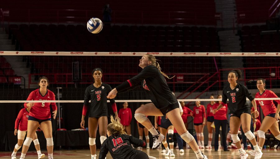 WKU defensive specialist Ashely Hood (11) jumps to save the ball during the match against St. John’s University at Diddle Arena on Sept. 18, 2021.