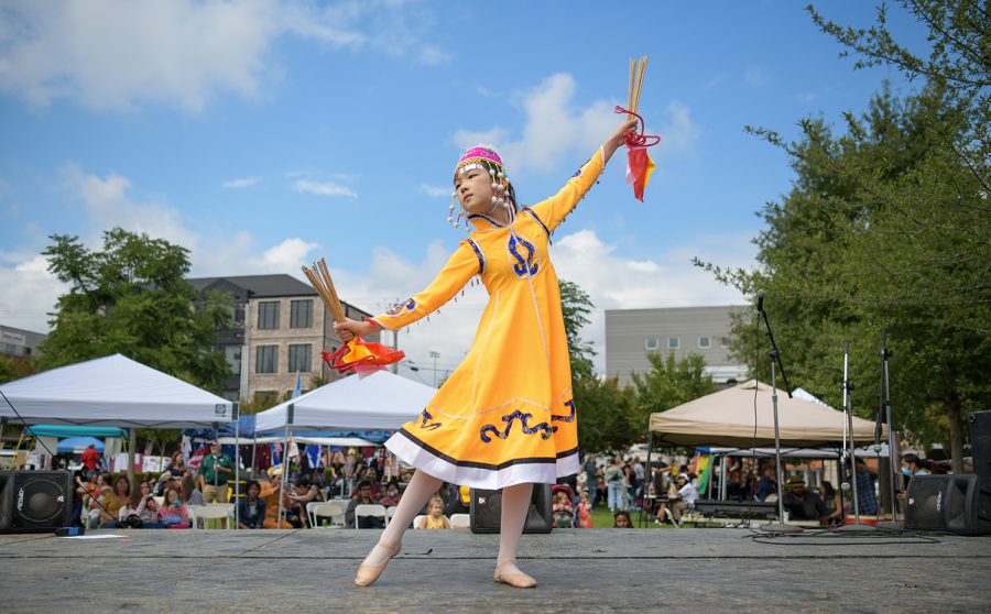 A young student of Cheryl Pan, a traditional Chinese dance instructor, performs on stage in Circus Square Park, Saturday, Sept. 25, 2021, for the Bowling Green International Festival.