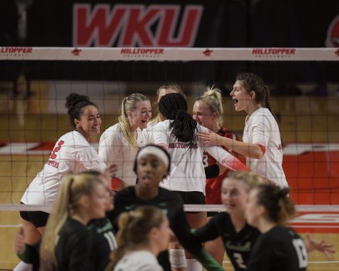 The WKU Hilltoppers celebrate after a point against the Marshall Thundering Herd on the evening of Sept. 24, 2021 during their volleyball match in Diddle Arena.