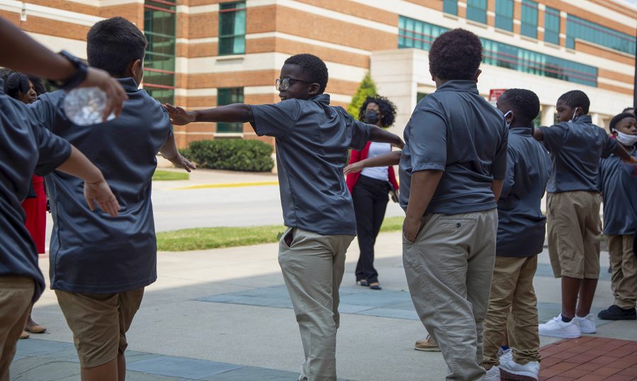 (Left to right) Matthew Rivas, Jordon Whitlow-Clark, Kamarious Day, Kavvyun Lockhart, Camdyn Bibb, and Kewan Williams are told to give each other space outside of Gary Ransdell Hall to take a group picture before heading to lunch in Downing Student Union.
