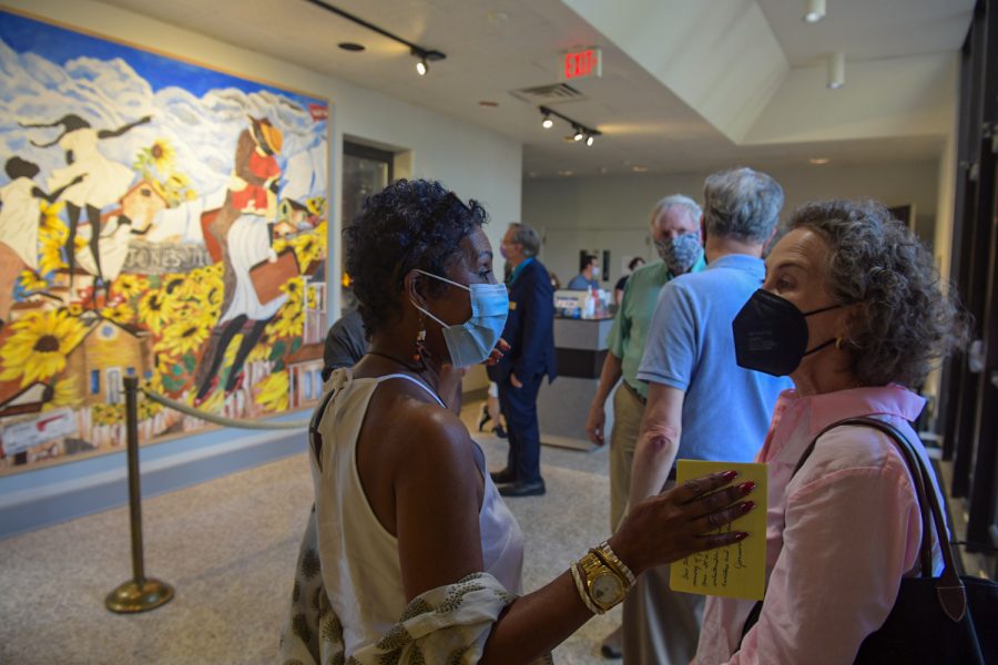 Artist Alice Gatewood Waddell (center) visits with an attendee of an artists talk for the fresco mural (pictured left) of Jonesville that she designed on Thursday, Sept. 16, 2021, at WKU’s Kentucky Museum.