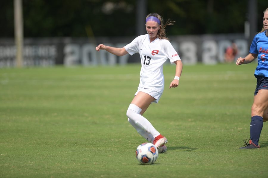 WKU junior forward Katie Erwin (13) dribbles past a defender during the Lady Toppers match against the Ole Miss Rebels on Sunday, Sept. 12 2021 at the WKU Soccer Complex. Ole Miss went on to win 1-0.