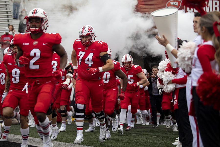 Western Kentucky University football team steps onto Feix Field in Houchens-Smith Stadium before the 2021 homecoming game against the Charlotte 49ers on Oct. 30.