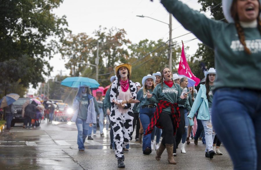 WKU sorority members dressed for the homecoming western theme march down State Street in the parade.