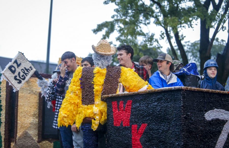 Members of Sigma Gamma Rho ride on a float in the homecoming parade Friday night. 