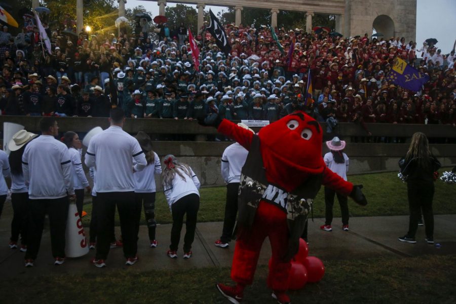 Big Red poses with WKU fraternities and sororities as they gather outside of the WKU Fine Arts Center after the 2021 homecoming parade. 