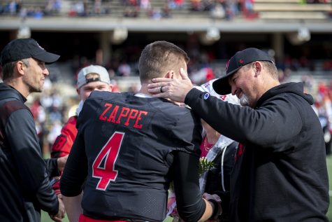 Hilltoppers’ graduate student Bailey Zappe (4) shares a moment with his father during their senior day celebration.