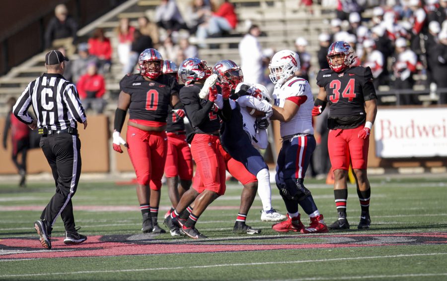 Hilltoppers’ defense carries a FAU player before dropping him to end the play during their matchup.