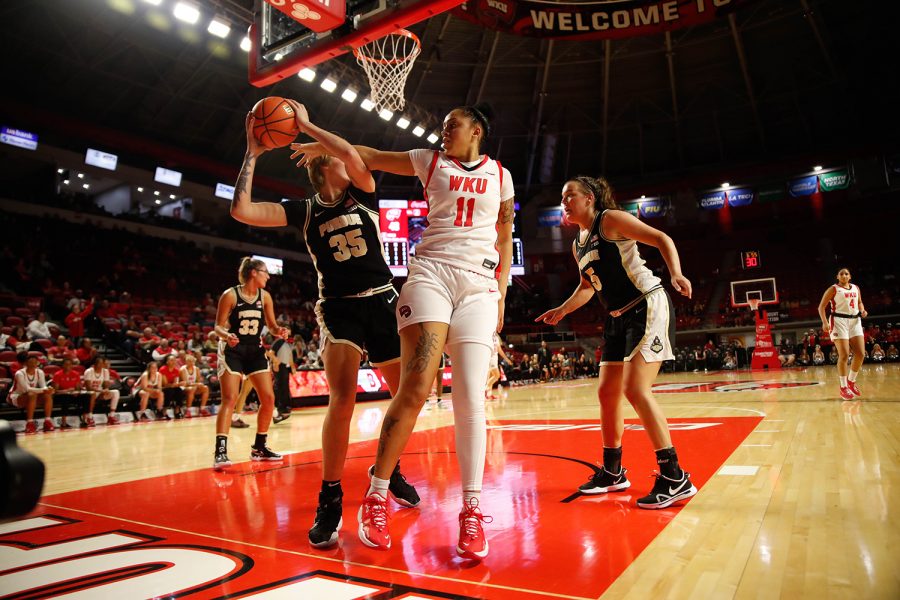 Lady Toppers’ freshman forward Jaylin Foster (11) attempts to gain possession from Purdue University Boilermaker junior forward Rickie Woltman (35) during their game on Nov. 10, 2021 in Diddle Arena.