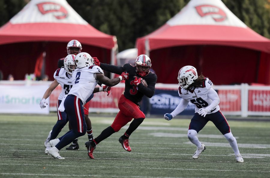 Hilltoppers’ sophomore running back Jakairi Moses (3) breaks through the FAU Owls’ defense to gain yardage during their matchup at Houchens-Smith Stadium.