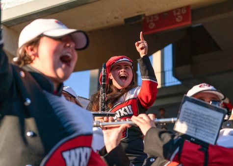 Larissa Stratton (center) celebrates after the WKU football team scores at touchdown during the game against MTSU at Houchens-L.T. Smith Stadium. Stratton is known for being very vocal in support of the WKU football team when at the games and cheering loudly.