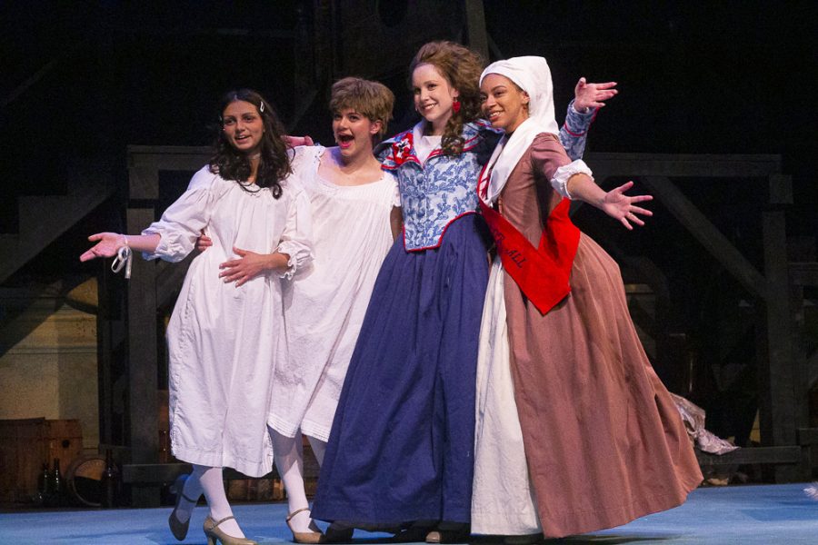 Actors Katarina Johnson, Ella Shahn Hagan, Elizabeth Garapic, and Jorah Graham celebrate after concluding their final technical run-through before the opening night of The Revolutionists in Russell Miller Theater on November 4, 2021.