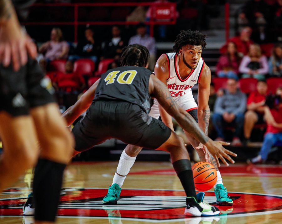 Hilltopper sophomore guard Dayton McKnight (20) brings the ball across half court against Alabama State University Hornets’ Isaiah Range (40) in Diddle Arena during their game on Nov. 9, 2021.