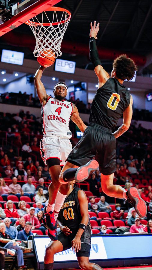 WKU 5th year guard Josh Anderson (4) goes up for a dunk against Alabama State University Hornet’s junior forward Trace Young (0) during their game in Diddle Arena on Nov. 9, 2021.