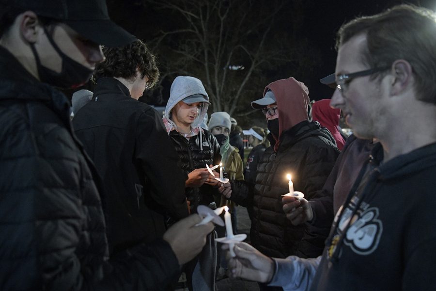 Logan McKnight, an 18-year-old WKU freshman from Dawson Springs, died on Wednesday, Nov. 24 of 2021 following a car accident the previous day.

The following week, Monday evening, Nov. 29, his friends and family held a candlelight vigil by Guthrie Bell tower on campus in his memory. 

Here, attendants assist one another in lighting candles.