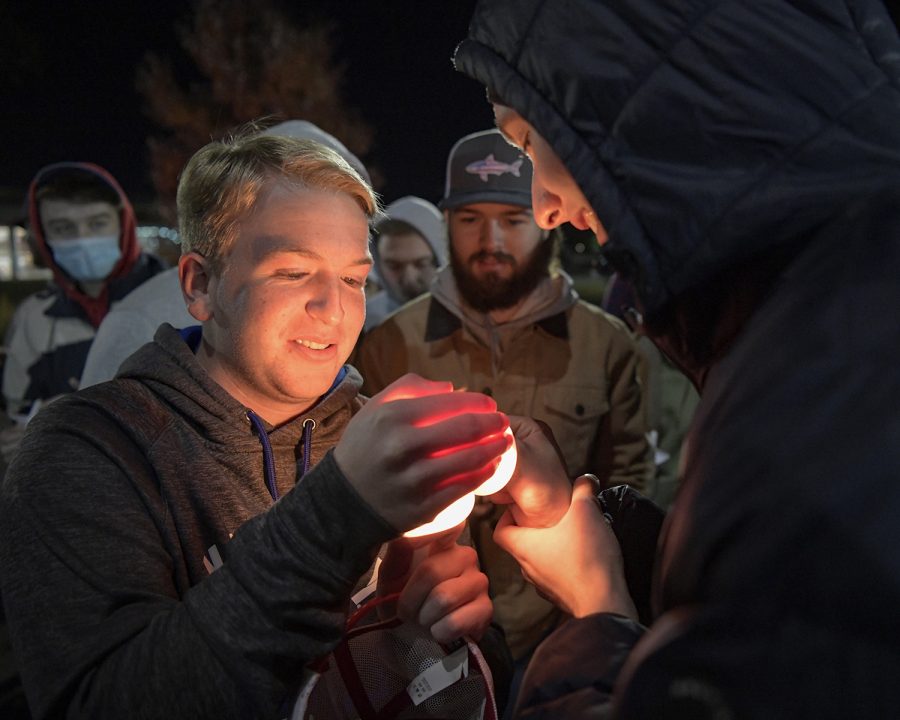 Logan McKnight, an 18-year-old WKU freshman from Dawson Springs, died on Wednesday, Nov. 24 of 2021 following a car accident the previous day. Tuesday.

The following week on Monday evening, Nov. 29, his friends and family held a candlelight vigil by Guthrie Bell tower on campus in his memory. 

Here, McKnight’s roommate, Allen Ross, helps another attendant light a candle. “We’d sometimes stay up till two or three in the morning talking about the most random shit,” he said while sharing words with the crowd.