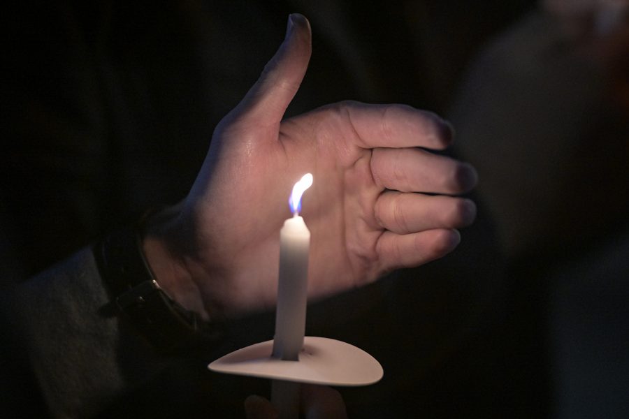 Logan McKnight, an 18-year-old WKU freshman from Dawson Springs, died on Wednesday, Nov. 24 of 2021 following a car accident the previous day. Tuesday.

The following week on Monday evening, Nov. 29, his friends and family held a candlelight vigil by Guthrie Bell tower on campus in his memory. 

Here, an attendant protects their candle from the wind.