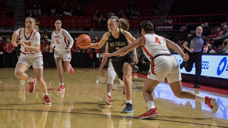 West Virginia State University Yellow Jackets’ sophomore guard Caroline Scott (3) drives against WKU Lady Toppers’ senior guard Meral Abdelgawad (4) during an exhibition match Wednesday evening, Nov. 3 of 2021 in Diddle Arena. WKU won the match 112-72.