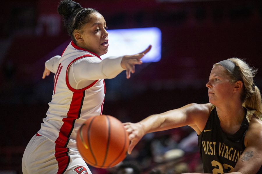 WKU Lady Topper freshman forward Jaylin Foster (11) attempts to block a pass by West Virginia State University Yellow Jacket junior guard Shelby Harmeyer (23) during their exhibition game.
