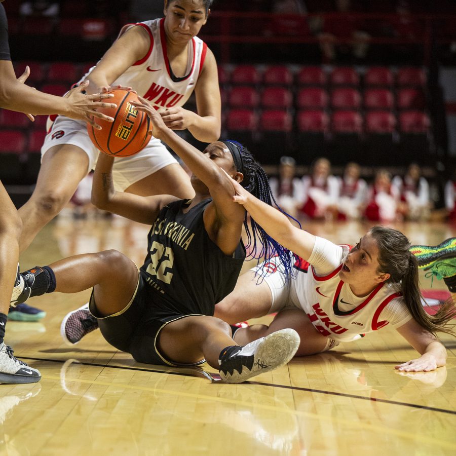 West Virginia State University Yellow Jacket sophomore guard ZZ Russell struggles with the ball against WKU Lady Toppers’ sophomore guard Teresa Faustino (14) and senior guard Medal Abdelgawd (4) during their exhibition game on Nov. 3, 2021, at Diddle Arena.