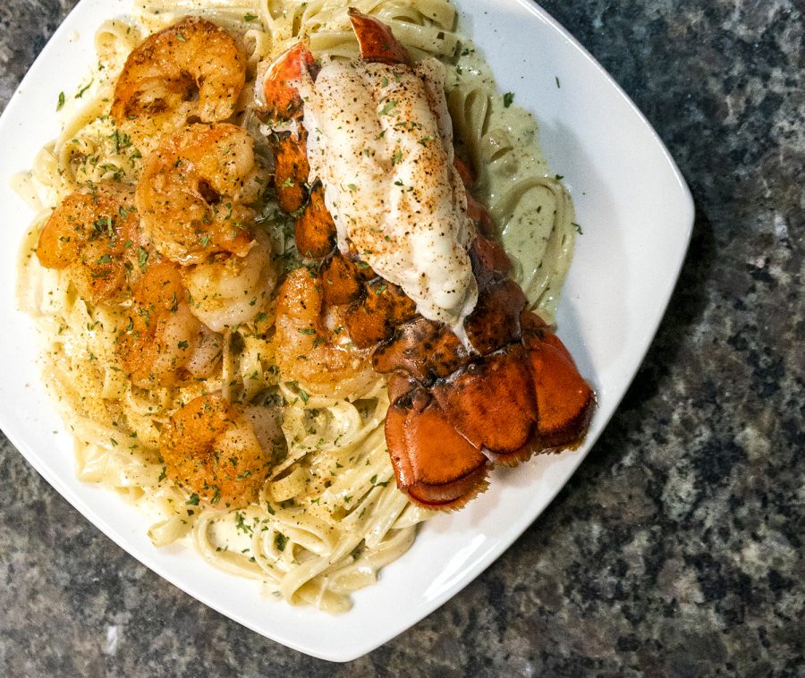C.J. Marria’s Cajun pasta with jumbo shrimp and lobster tail rests on his kitchen counter.
