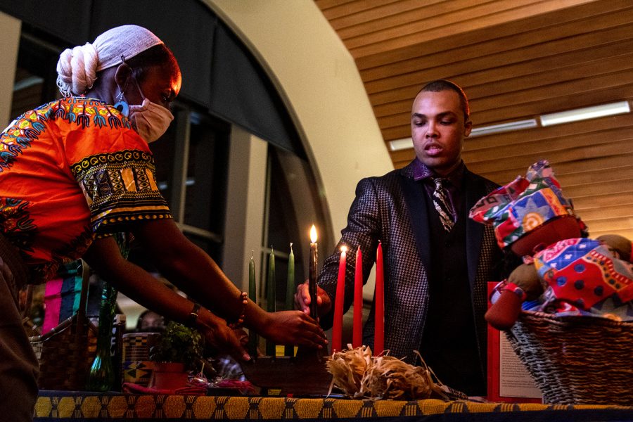 Noah Gordon from BlaqArt Nouveau lights the second candle before performing a speech during the Kwanzaa celebration on Dec. 2, 2021 in the Downing Student Union. His speech focused on how people of color are tokenized by white people.