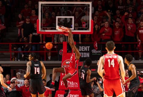 WKU center Jamarion Sharp (33) dunks to give WKU a point during the WKU v University of Louisville basketball game at Diddle Arena on Dec. 18, 2021.