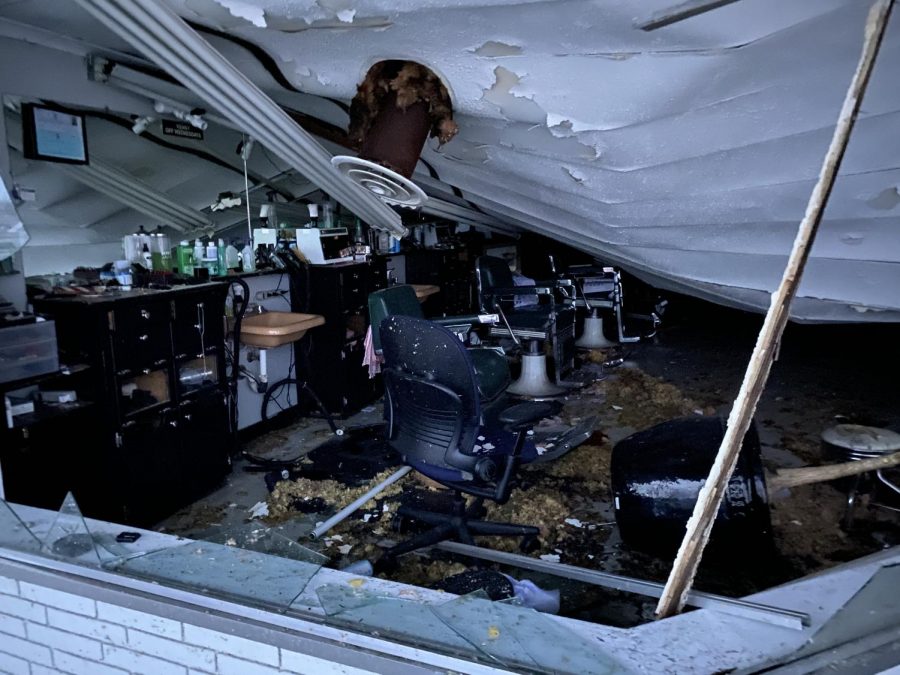 The front window of Pauls Barber Shop was destroyed by the storm, exposing its interior to the elements.