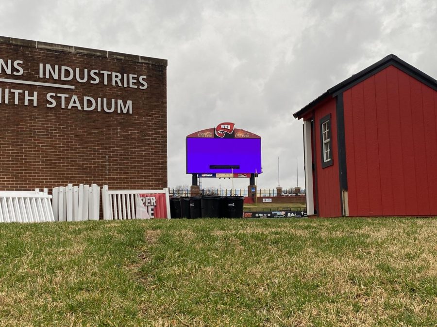 The scoreboard at Houchens-Smith Stadium lit up in a sickly purple color in the early morning hours.