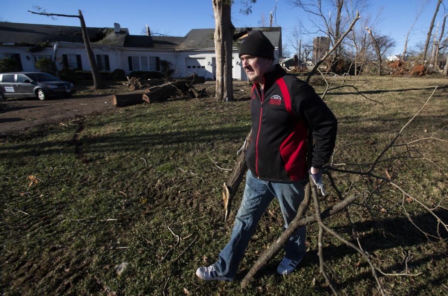 Rick Stansbury, head coach of the WKU Hilltoppers basketball team, helps clear brush on Craig Street near WKU’s campus. Stansbury cleared debris with members of the team, who cleaned up in place of practice. “We will get more out of this than from having practice,” Stansbury said.