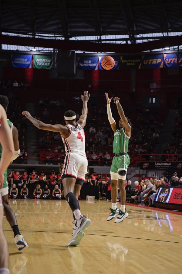 North Texas Mean Green’s senior guard Madrez McBride  (1) leaps for a three-pointer against the WKU Hilltoppers on the afternoon of Saturday, Jan. 15 2022, in Diddle Arena. North Texas won the match 65-60.