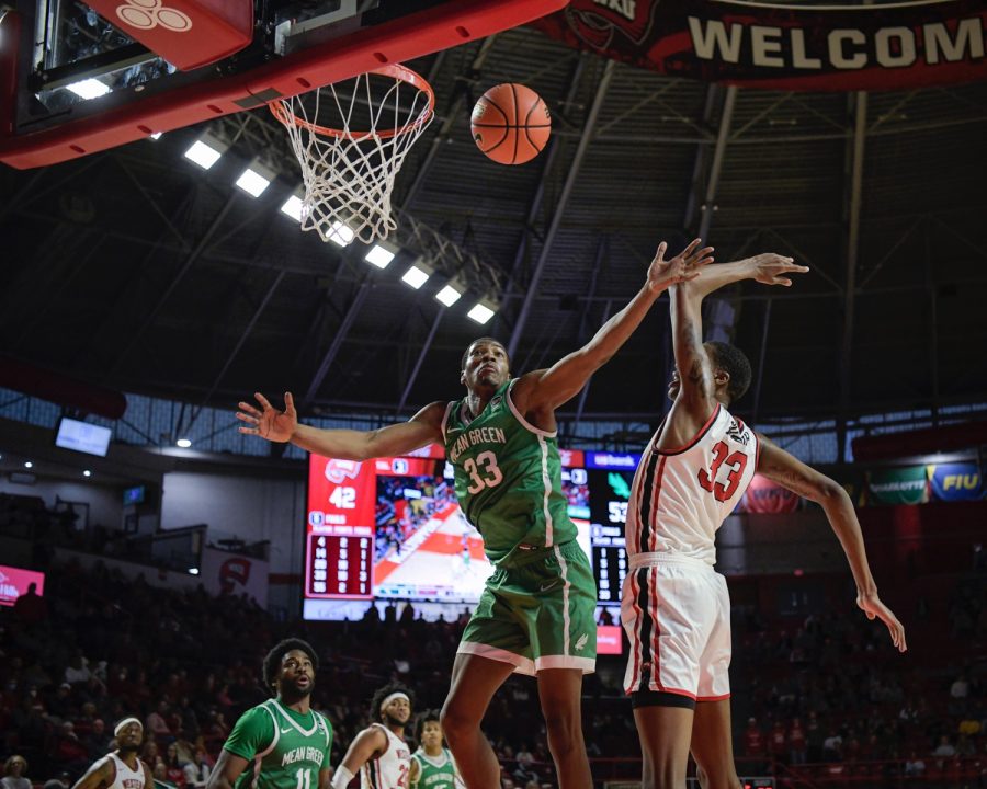 North Texas Mean Green’s sophomore forward Abou Ousmane (33) blocks a two-point shot by WKU Hilltoppers’ junior center Jamarion Sharp (33) on the afternoon of Saturday, Jan. 15 2022, in Diddle Arena. North Texas won the match 65-60.