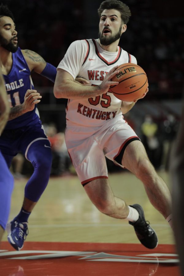 Graduate+guard+Camron+Justice+drives+to+the+paint+against+MTSU+on+Saturday%2C+Jan.%2C+29.+WKU+lost+93-85.+