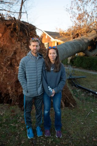 Cort and Laurie Basham stand in front of the tree that fell on their home the day before. “The stuff
that really affects me is the unbelievable response from our community,” Basham said.