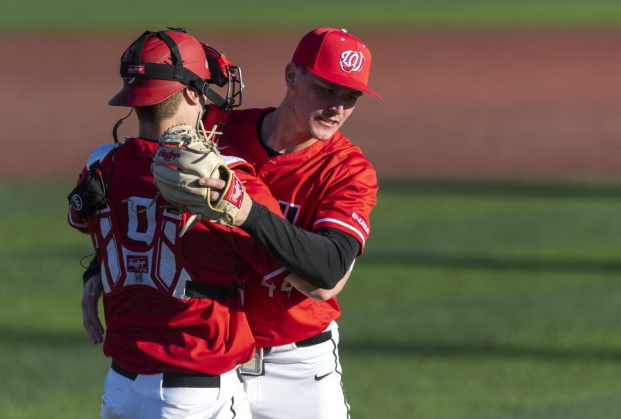 WKU junior pitcher Mason Vinyard is embraced by his teammate after striking out the final batter during the game against Western Illinois University at Nick Denes field on Feb. 20, 2022, making the Hilltoppers win 9-6.