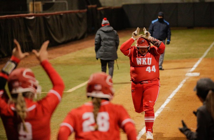 WKU Softball's fifth year utility/catcher Bailey Curry (44) celebrates with her teammates after hitting a three-run home run during their matchup with Bellarmine University on Feb. 18 at the WKU Softball Complex.
