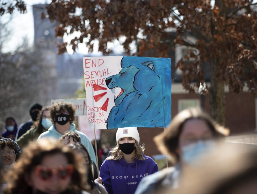 Students taking part in the protest against sexual assault and violence walk up the hill beside Grise Hall on Friday, Feb. 18. 