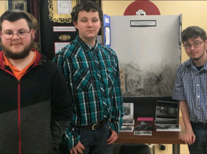 DJ Stover (right) stands with Pierson Salyers (left) and Michael Hovis (center) while attending high school. Pierson and Michael, friends of DJ, ran together from the shooting at Marshall County High School in 2018.
