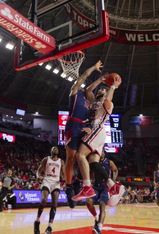 Hilltoppers graduate guard Camron Justice (55) drives to the basket attempting to draw the foul from Florida Atlantic University Owls freshman guard Alijah Martin (15) during their matchup on Feb. 10 in Diddle Arena.
